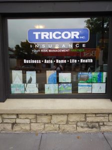 Student art hanging in the window of Tricor insurance