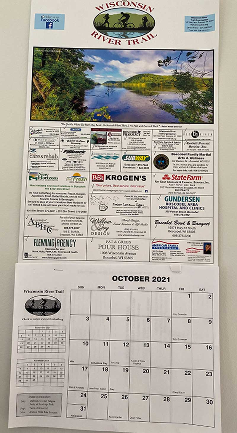 WRTO’s printed community birthday calendar featuring local business ads and trail photos.